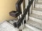 Wooden handrail with steel pipes for granite finished staircase steps like tread and risers of an high rise building apartment