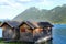 Wooden hangar on water, boathouse for boats and boats on stilts, surface of mountain lake Achensee in Austria, Alps mountains in