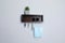 Wooden hanger for keys with wallet, sunglasses, medical masks and houseplant on white wall