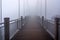 Wooden hanging bridge at Tianmen Mountain vanishing in very heavy mist or fog. Halloween or horror concept