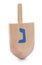 Wooden Hanukkah traditional dreidel with letter Nun isolated on white
