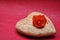 A wooden heart displayed with an orange rose