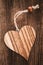 Wooden heart on natural background with a string