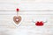 Wooden heart on rope and figurines of pigeons with hearts. Concept for Valentine`s Day, wedding, engagement and other romantic