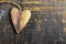 Wooden heart on scratched wooden table. Love concept.