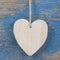 Wooden heart shape on blue wooden surface for valentine, birthday or wedding greeting card.