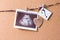 a wooden heart and an ultrasound image pinned to a rope on a cork board