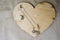 A wooden heart for Valentine`s Day with silver earrings with diamonds, precious stones, rhinestones