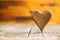 Wooden heart on wooden table.