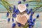 Wooden hearts with blue muscari flowers on old wooden background