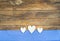 Wooden hearts border on blue and white checkered fabric.