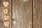 Wooden hearts and LOVE letters side border on rustic wood