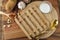 Wooden heating pad with a glass of milk and spoon and fork with blank text space