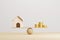 Wooden home and money coins stack on wood scale