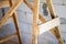 Wooden homemade scaffolding close-up against the background of a bare aerated concrete wall