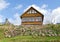 Wooden homestead house hill stone blue cloudy sky