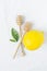 Wooden Honey Dippers Ripe Yellow Lemon Green Citrus Leaves on White Cotton Linen Fabric Background. Organic Cosmetics