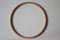 Wooden hoop for embroidery on beige background. Top view.