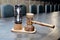 Wooden hourglass and mallet on the table