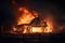 A wooden house or barn burning at night on fire