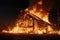 A wooden house or barn burning at night on fire