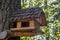 Wooden house for birds with original roof close-up