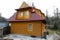 Wooden house with the complicated roof structure