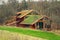 Wooden house with extensive green living roof covered with vegetation