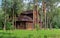 Wooden house in the forest. Log cottage among the trees