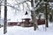 Wooden house in forest in winter time. Log cabin in the forest alone in wilderness. Wooden houses with a wooden roof against