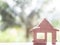 Wooden house on a green blur bokeh background. Love nest, relationships. Buying a house . Affordable housing. concept idea