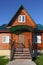 Wooden house with green metal roof front steps view