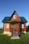 Wooden house with green metal roof front on view