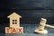 Wooden house with the inscription `Tax` and the judge`s hammer. Taxes on real estate, payment. Penalty, arrears. Register of taxp