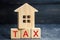 Wooden house with the inscription `Tax`. Taxes on real estate, payment. Penalty, arrears. Register of taxpayers for property. Law-