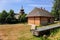 Wooden house next to the antique regional church in historic Polish village, Lesser Poland region, Poland