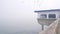 Wooden house on piles in water, Ocean Beach pier, foggy California coast, USA.