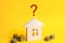 Wooden house and question mark. review of the house, the best offer of purchase. Buying, selling and renting a real estate. Loan f