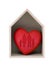 Wooden house and red heart with imprinted family shape