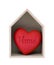 Wooden house and red heart with imprinted word home