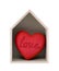 Wooden house and red heart with imprinted word love