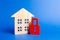 Wooden house and a red padlock. Security and safety. Confiscation for debts. alarm system. seizure of property.