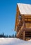 Wooden house with satellite equipment in the woods against the sky.