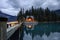 Wooden house shining in pine forest on Emerald lake in Yoho national park