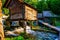 a wooden house with a small water fall running underneath it