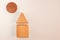 Wooden house and sun above with shadows on white background. Simple geometric figures square, triangle, circle as concept of kids