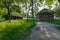 A wooden house with a thatched roof and a cowshed with beams and branches. Simple and practical