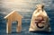 Wooden house and a ukrainian hryvnia money bag. Home purchase, investment in real estate construction. House project development.