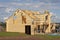 Wooden house under construction. Family build new home in green landscape. super commercial stock photo