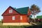 Wooden house under green metal roof